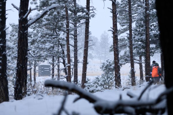 packing for a late season hunt hunter walking to ambush blind in snow covered forest