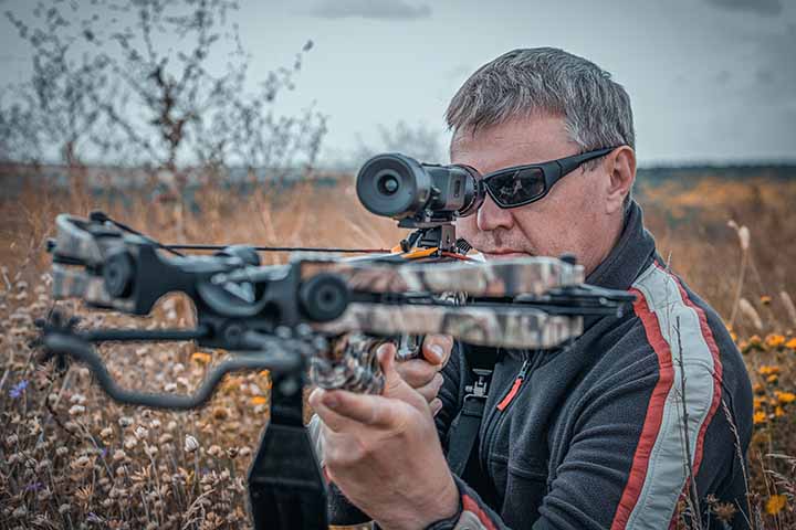 A man with a raised crossbow